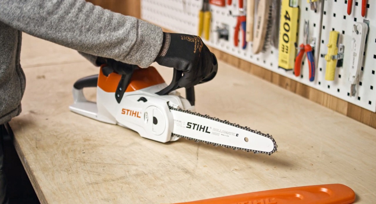 Чоловік збирає акумуляторну бензопилку STIHL MSA 120